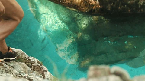Active Senior Jumping In The Crystal Clear Alpine Water From A Rock Ledge Stock Footage 94031954