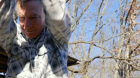 Active Senior Man Chops Firewood as Green Fuel Source for Winter Stock Footage 84288243