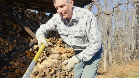 Active Senior Man Chops Firewood Stock Footage 84289495