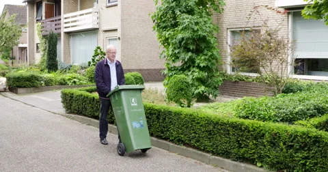 Active senior man with garbage can Stock Footage 57262852