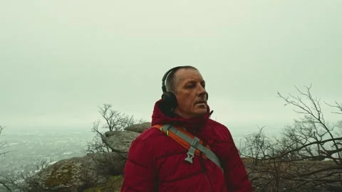 Active Senior Man in Red Jacket Navigating Misty Forest Path Video stock 330911751