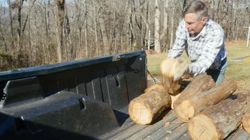 Active Senior Man Unloads Firewood Logs from a Pickup Truck in 4k Stock Footage 85966513