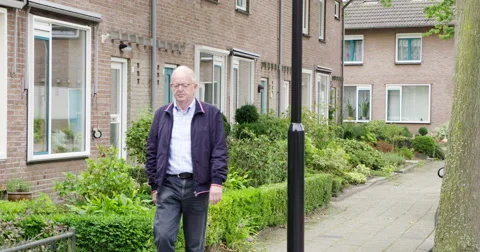 Active senior man walking residential street Stock Footage 57262589
