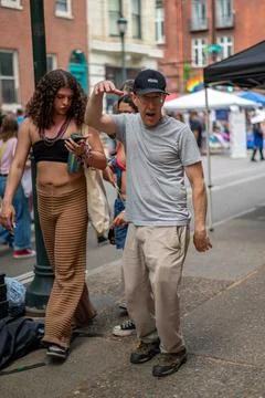 Active senior strikes a funny pose on crowded street Pride Fest Philadelphia Stock Photos