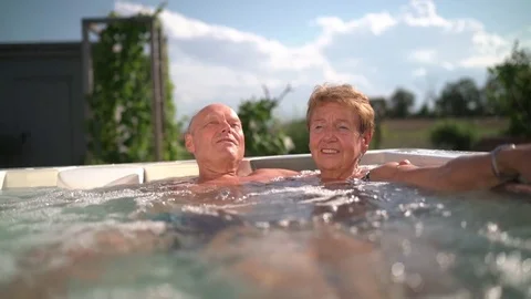 Active seniors in jacuzzi in garden Stock Footage 78528028