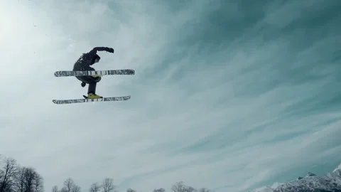 Active skier jumping from a height. Extreme sports in the winter mountains Stock Footage 144338028