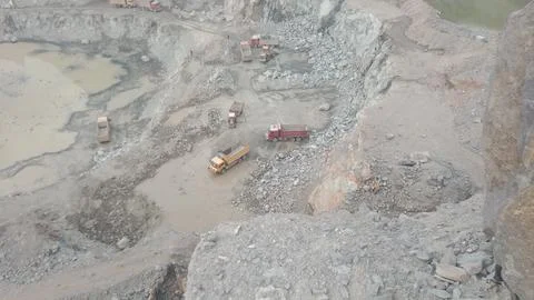 Active Stone Crusher and Mining Operations with Dump Trucks and Loaders. Stock Photos