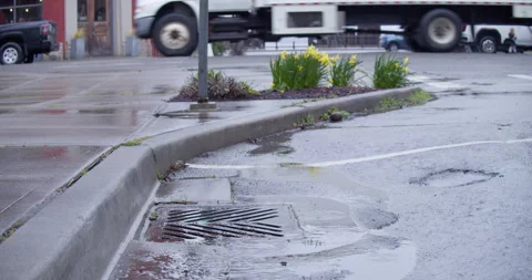 Active storm drain downtown in small town Stock Footage 175697882