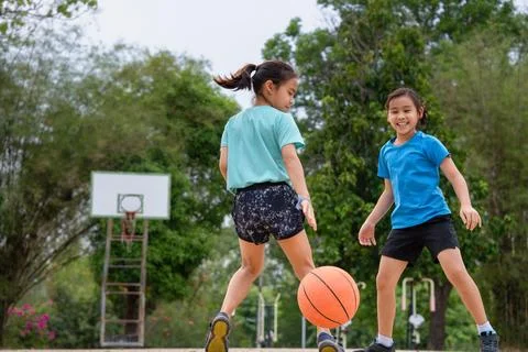 Active students practicing basketball drills during physical education class Stock Photos