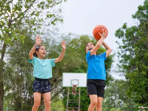 Active students practicing basketball drills during physical education class Stock Photos