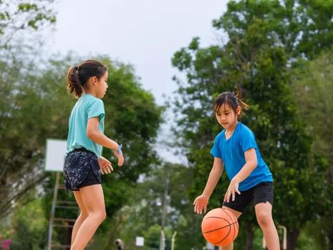 Active students practicing basketball drills during physical education class Stock Photos
