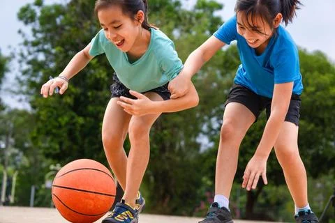 Active students practicing basketball drills during physical education class Stock Photos