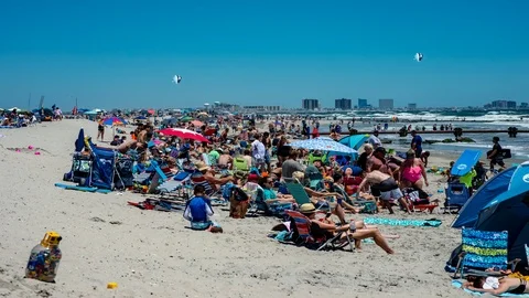 Active sunny day with people on the beach in Ocean City, New Jersery with Stock Footage 92382287