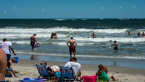 Active sunny day with people on the beach in Ocean City, New Jersery with Stock Footage 92390028