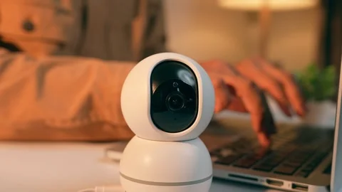 The active surveillance camera and a freelancer at their laptop. Stock Footage 317600350