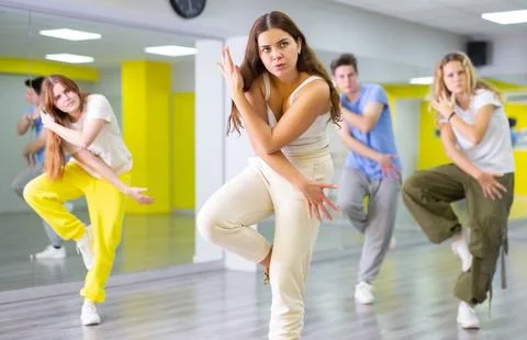 Active talented performing dance elements during lesson in modern fitness studio Foto stock