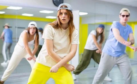 Active talented performing dance elements during lesson in modern fitness studio 库存照片