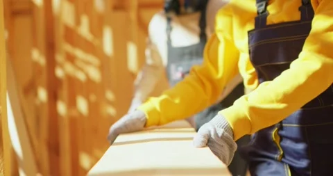 Active team of workers building wooden frame house on pile foundation. Stock Footage 255845064