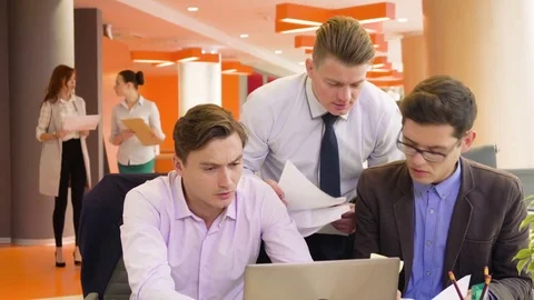 Active teamwork of young energetic colleagues, working and brainstorming Stock Footage 82539874