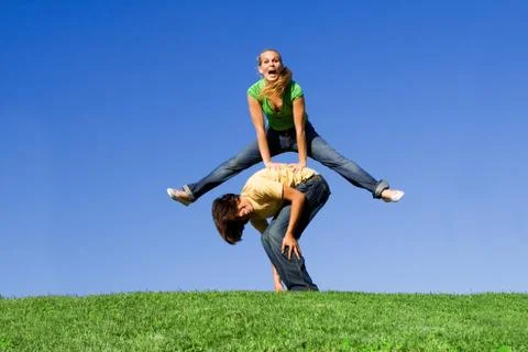Active teens playing leapfrog Stock Photos