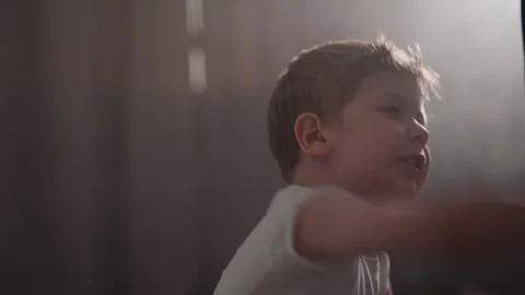 Active toddler in boxer gloves fights with punching bag Stock Footage 243310784