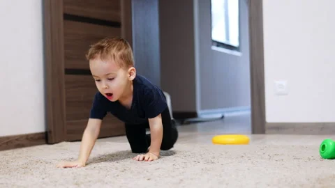 Active toddler boy crawling by the carpet.  Stock Footage 265031292