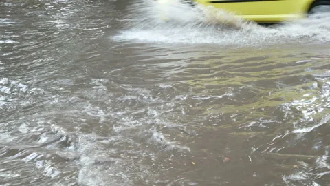 Active venicle traffic through flooded road after downpour with water Stock-Footage 140766465