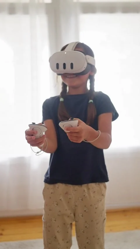 Active virtual reality play, child engages energetically with vr controllers Stock Footage 319966678