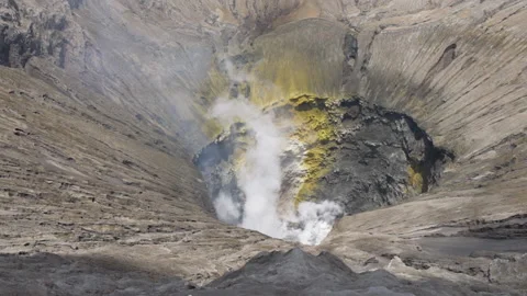 Active volcanic crater of Mount Bromo, Indonesia with smoke in slow motion Stock Footage 174893779