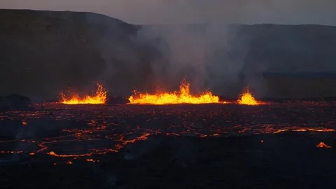 Active volcano eruption in Iceland. Boiling lava river. Smoke above crater. Stock Footage 266821959