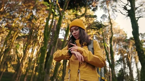 Active Woman Using Smartwatch While Hiking in Forest Stock Footage 276194164