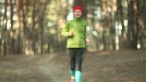 Active women's trail running in forest in the sunny day. Stock Footage 47224660
