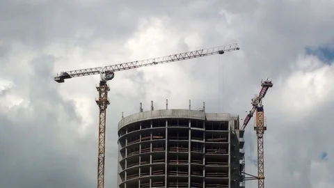 Active work of building cranes on a high-rise building in time lapse motion Stock Footage 81775317