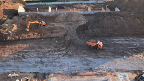 Active work of the tractor over the cottage town drone view Video stock 174810724