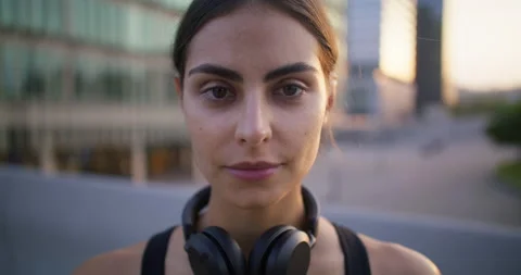 Active young female model smiles gladfully satisfied after morning jogging has Stock Footage 159727007
