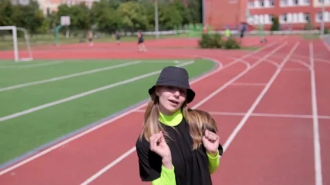 Active young girl dancing hip hop and break dance on the stadium treadmill Stock Footage 138992847