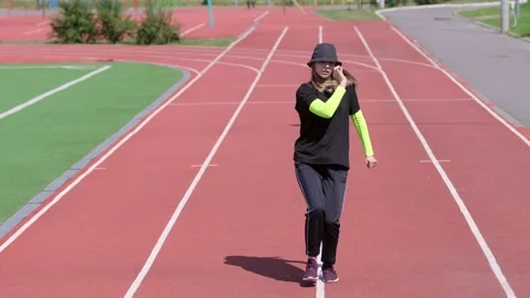 Active young girl dancing hip hop and break dance on the stadium treadmill Stock Footage 138993024