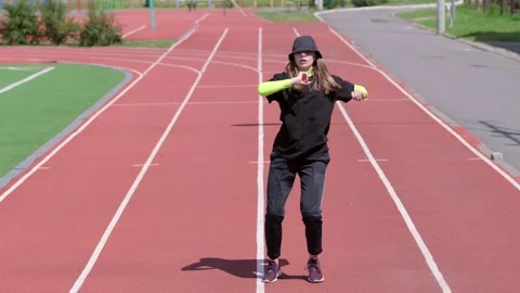Active young girl dancing hip hop and break dance on the stadium treadmill Stock Footage 138993036