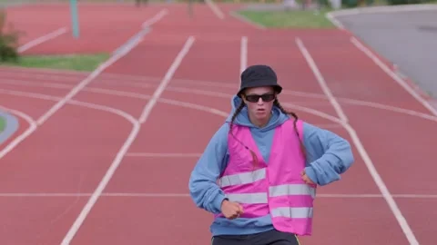 Active young girl dancing hip hop and break dance on the stadium treadmill Stock Footage 139458281