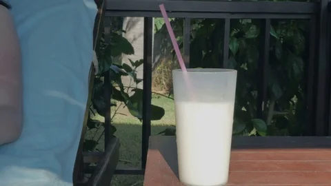 Active young girl drinks a cocktail on the beach, by the pool on a lounger. Stock Footage 80448174