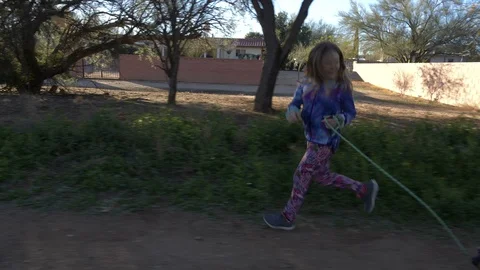 An active young girl running with her dog in the park Stock Footage 100711394