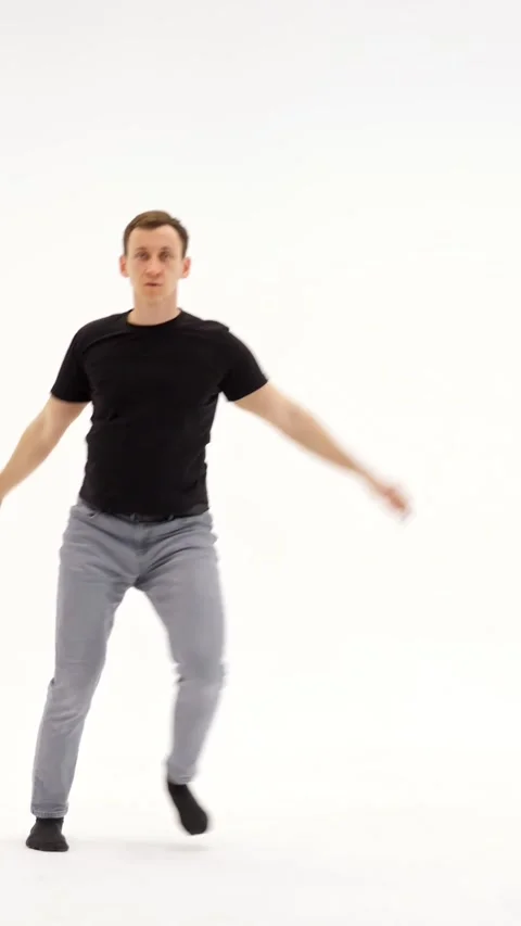 Active Young Man Dances Passionately In Bright Studio Setting. Expressive Dancer Stock Footage 347191065