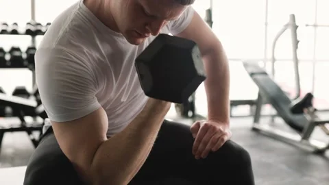 Active young man engaging in a challenging weightlifting routine, focusing on Stock Footage 241415338