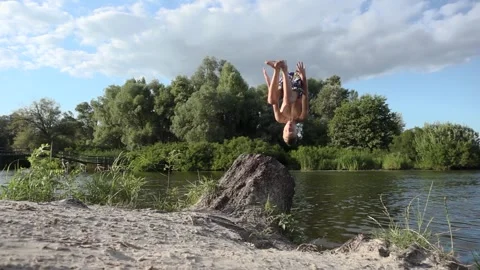 Active Young Man Performing Backflip Jump Into Picturesque Lake on Summer Day Stock-Footage 340398579