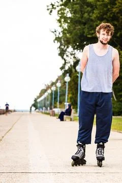 Active young man rollerskating outdoor. Stock Photos