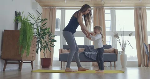 Active young mom and cute little kid daughter play on mat at living room, happy Stock-Footage 148221122