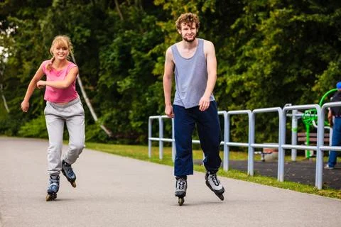 Active young people friends rollerskating. Stock Photos