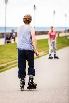 Active young people friends rollerskating. Stock Photos