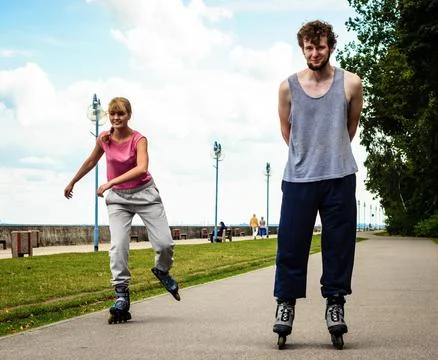 Active young people friends rollerskating. Stock Photos