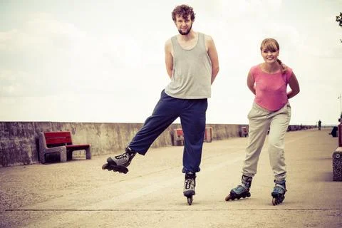 Active young people friends rollerskating. Stock Photos
